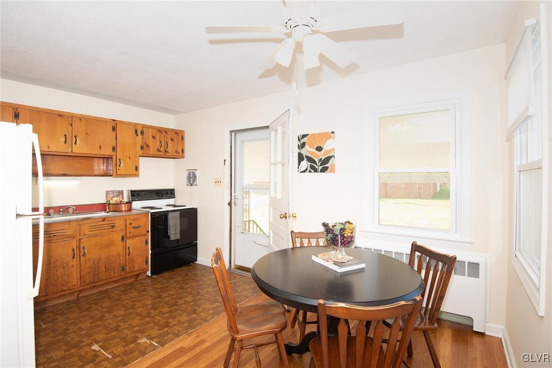 3003 Cornwall Road Bethlehem, PA 18017 - Photo 5 of 27 a kitchen with stainless steel appliances granite countertop a stove a refrigerator a sink a dining table and chairs with wooden floor