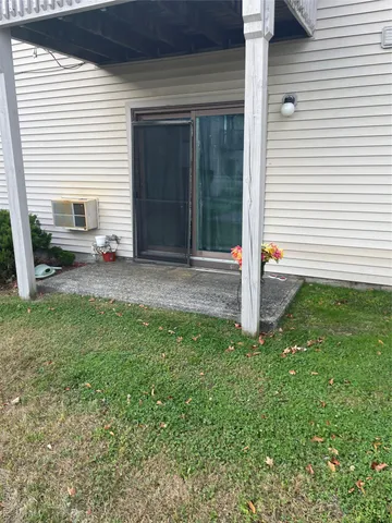 a backyard of a house with table and chairs