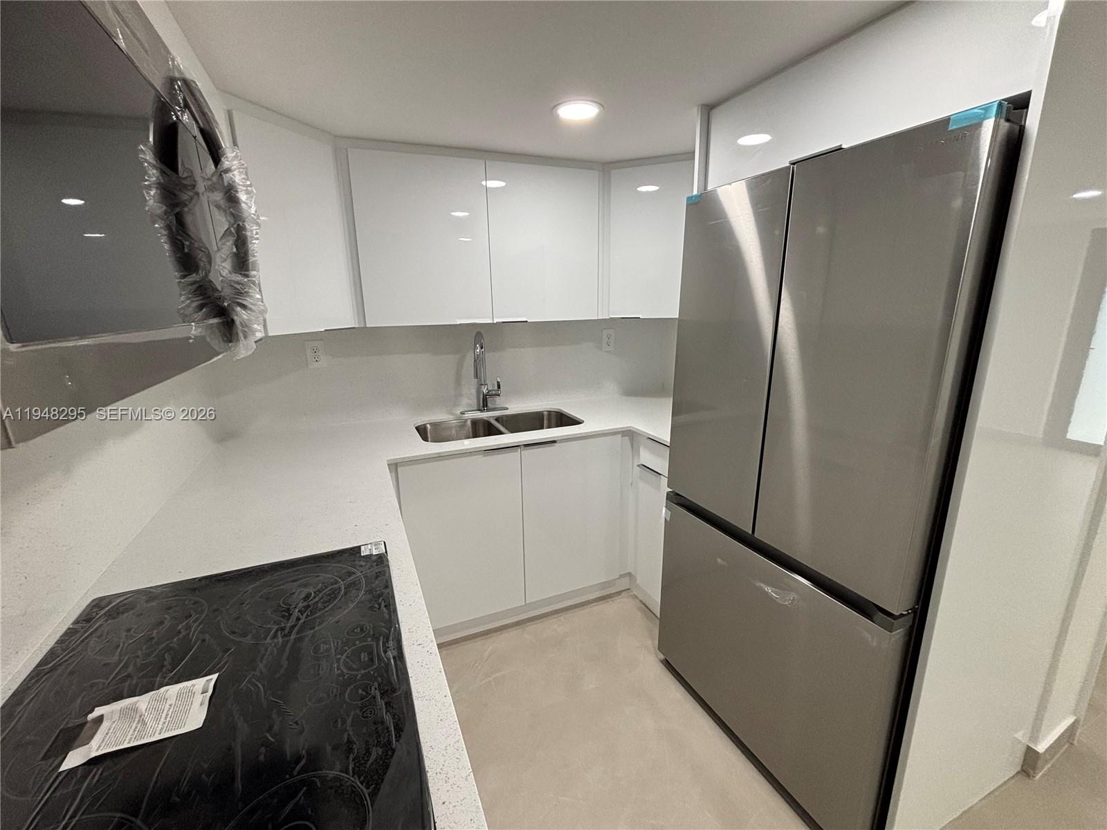 30 East 44th Street, Unit 30 Hialeah, FL 33013 - Photo 1 of 16 a kitchen with metallic refrigerator and sink