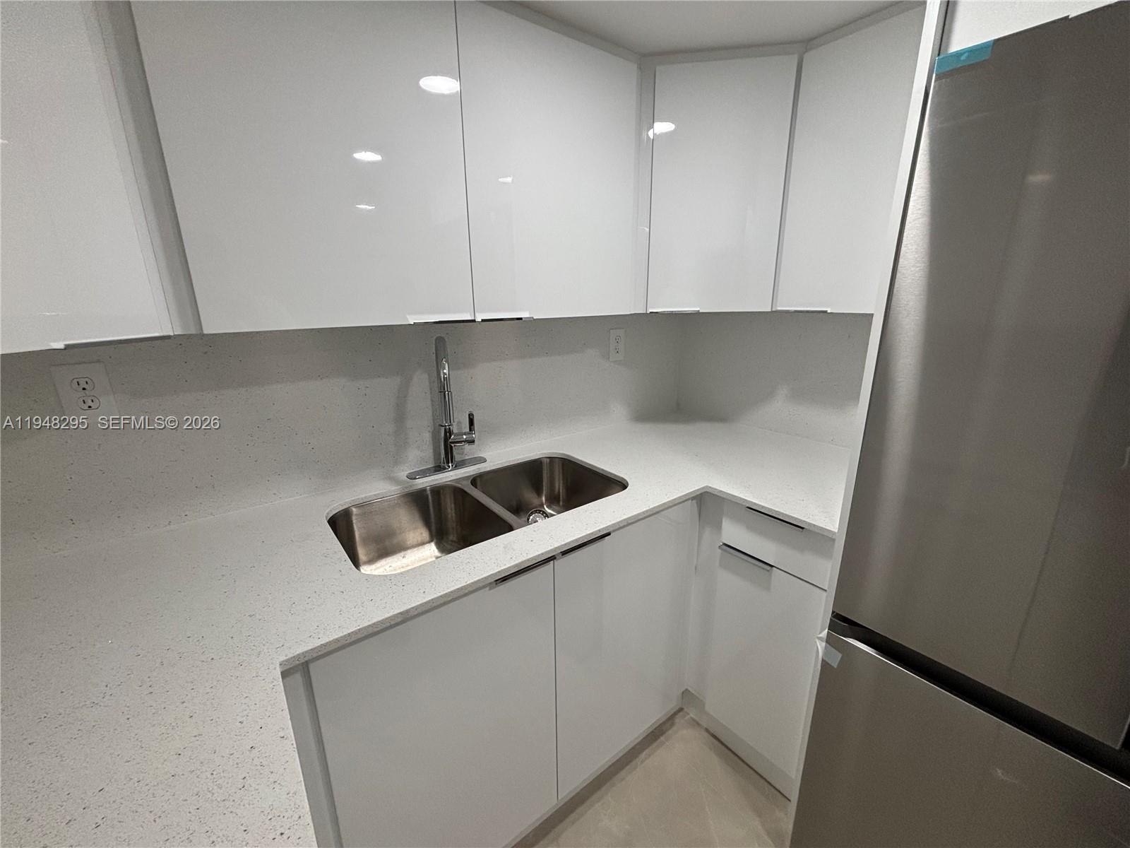 30 East 44th Street, Unit 30 Hialeah, FL 33013 - Photo 11 of 16 a kitchen with a sink and cabinets