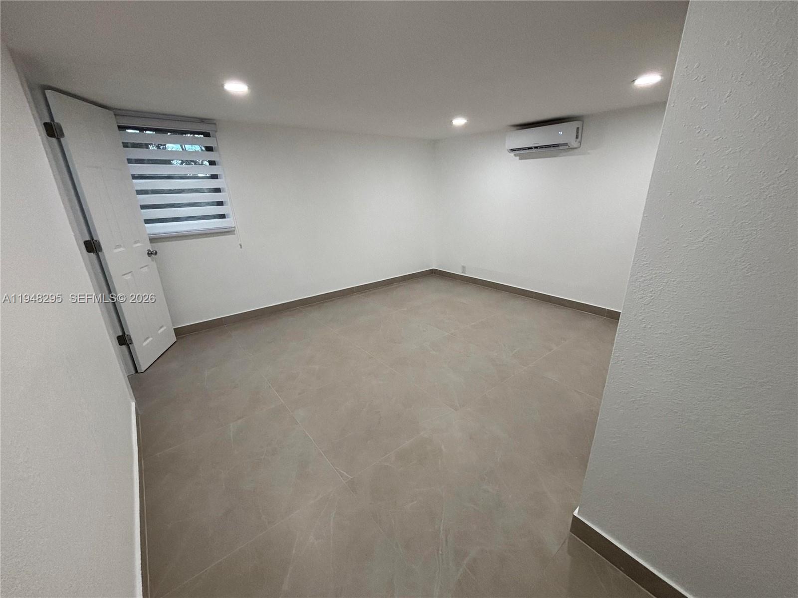 30 East 44th Street, Unit 30 Hialeah, FL 33013 - Photo 12 of 16 an empty room with a empty space and windows