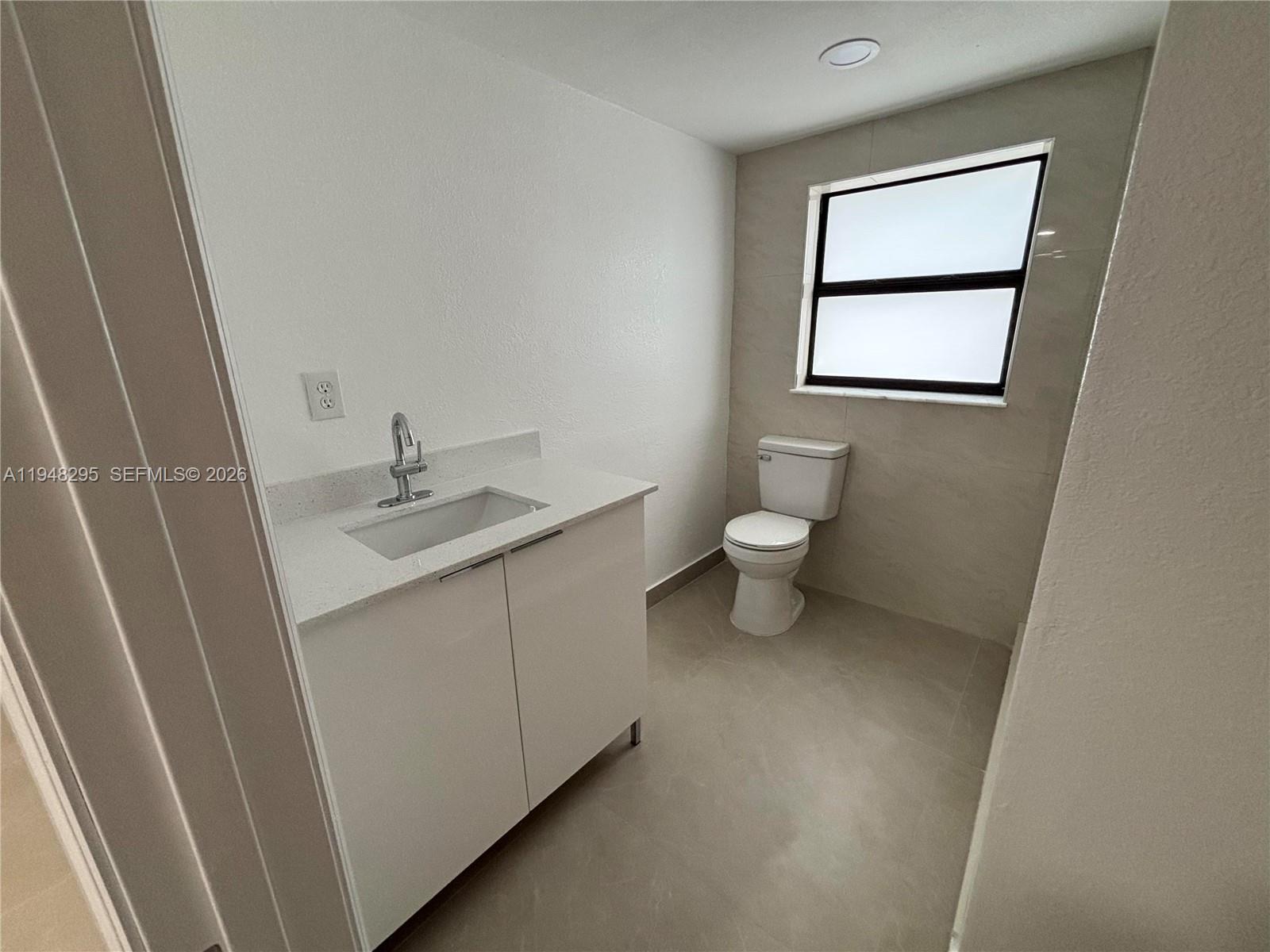 30 East 44th Street, Unit 30 Hialeah, FL 33013 - Photo 15 of 16 a bathroom with a sink toilet and vanity