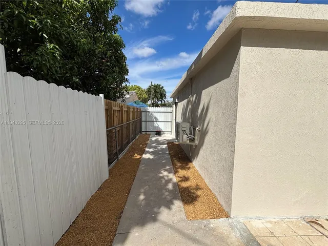 a view of a balcony with wooden floor and fence