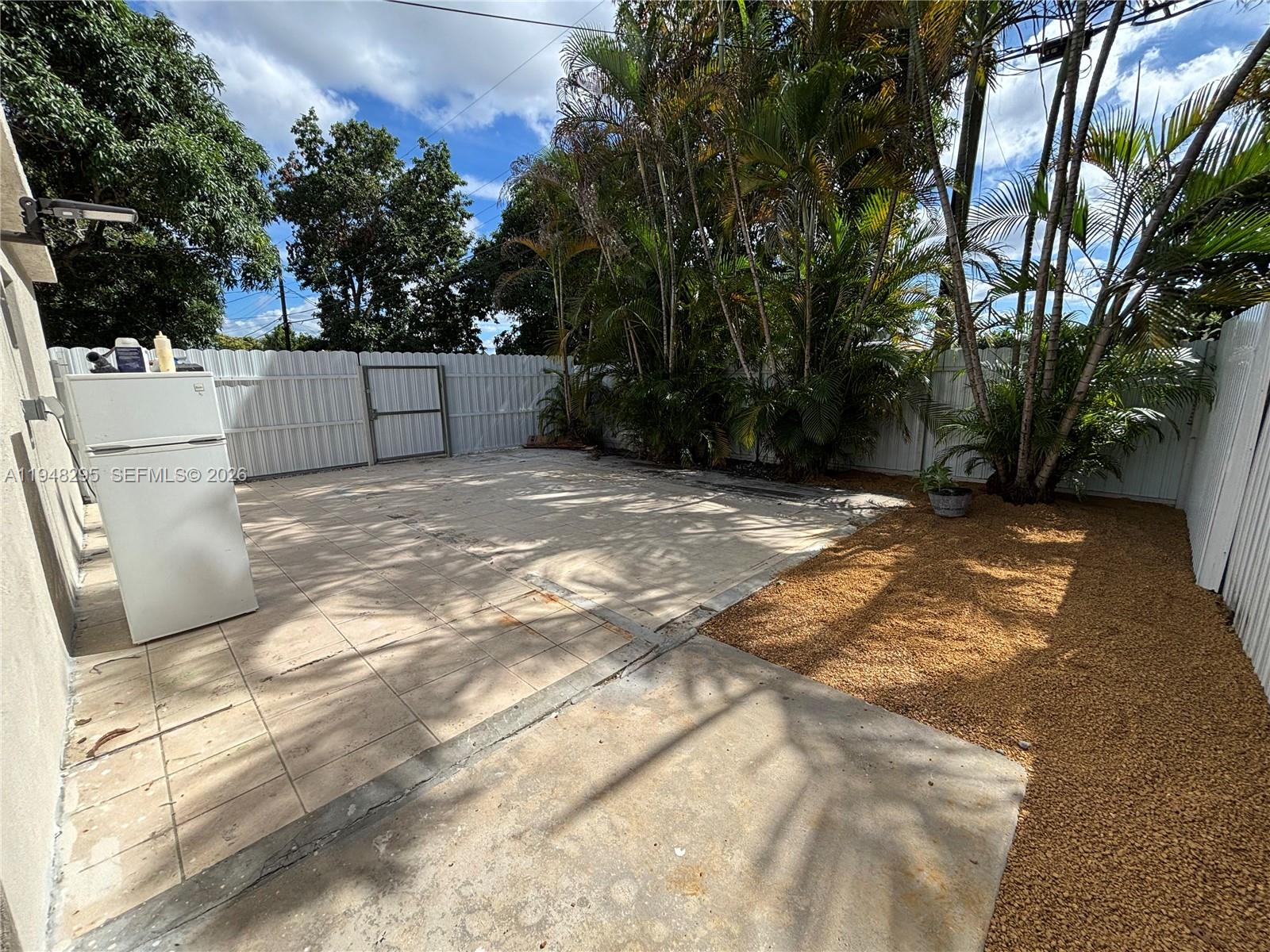 30 East 44th Street, Unit 30 Hialeah, FL 33013 - Photo 7 of 16 a backyard of a house with lots of green space and fountain