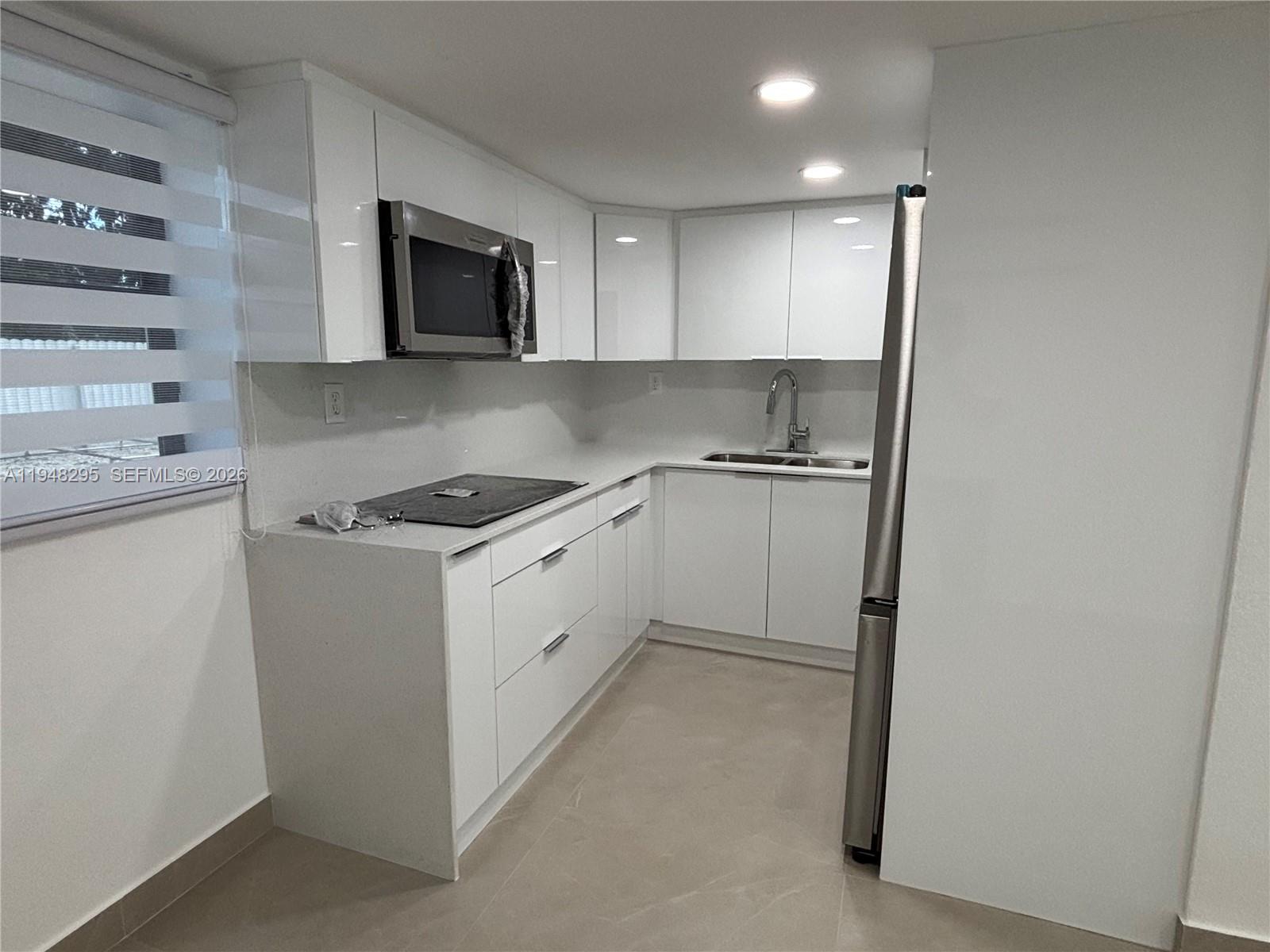 30 East 44th Street, Unit 30 Hialeah, FL 33013 - Photo 10 of 16 a kitchen with a stove microwave and sink