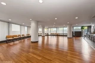 a view of a room with kitchen island lot of furniture and wooden floor