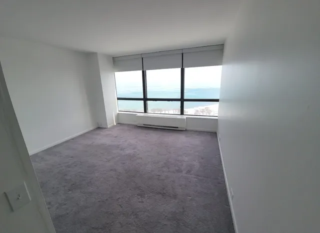 an empty room with large windows