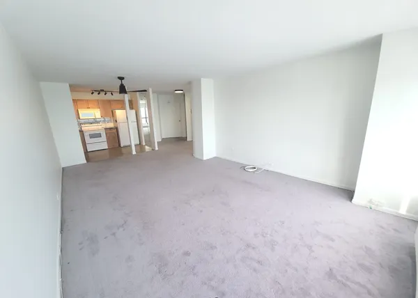 a view of a room with window and a kitchen