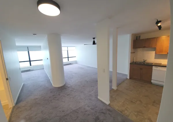 an empty room with windows and entrance