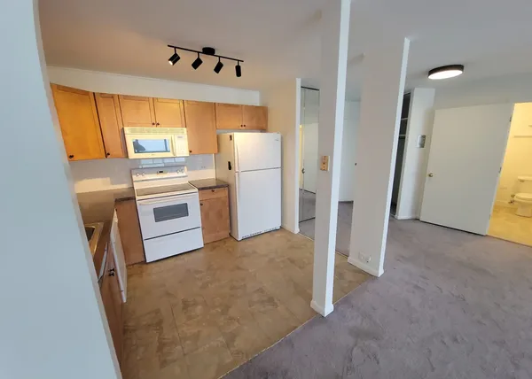 a kitchen with stainless steel appliances a refrigerator and a stove