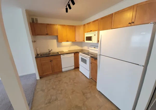 a kitchen with stainless steel appliances a refrigerator sink and microwave