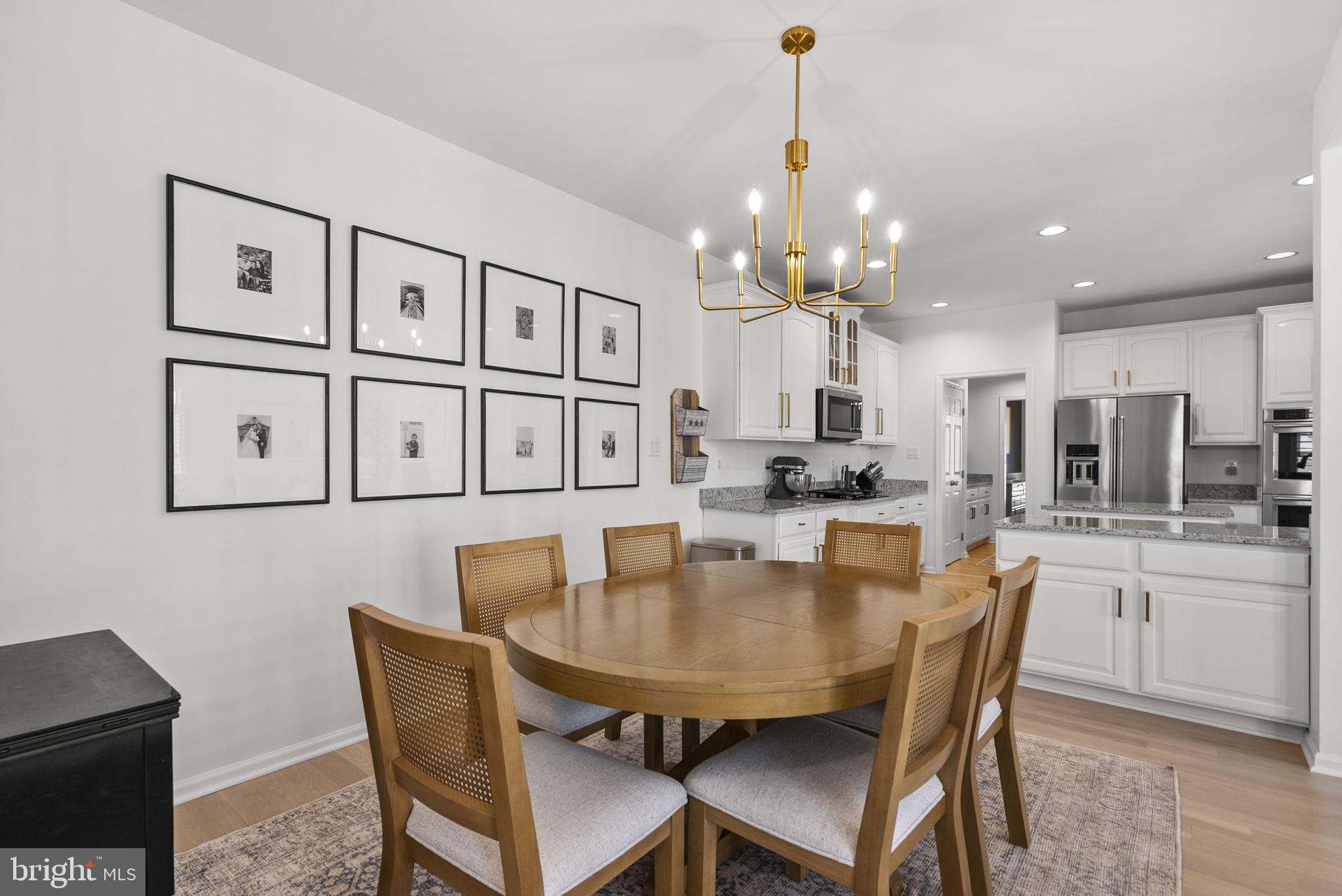 1339 Main Street Gaithersburg, MD 20878 - Photo 23 of 73 a dining room with stainless steel appliances kitchen island a table and chairs