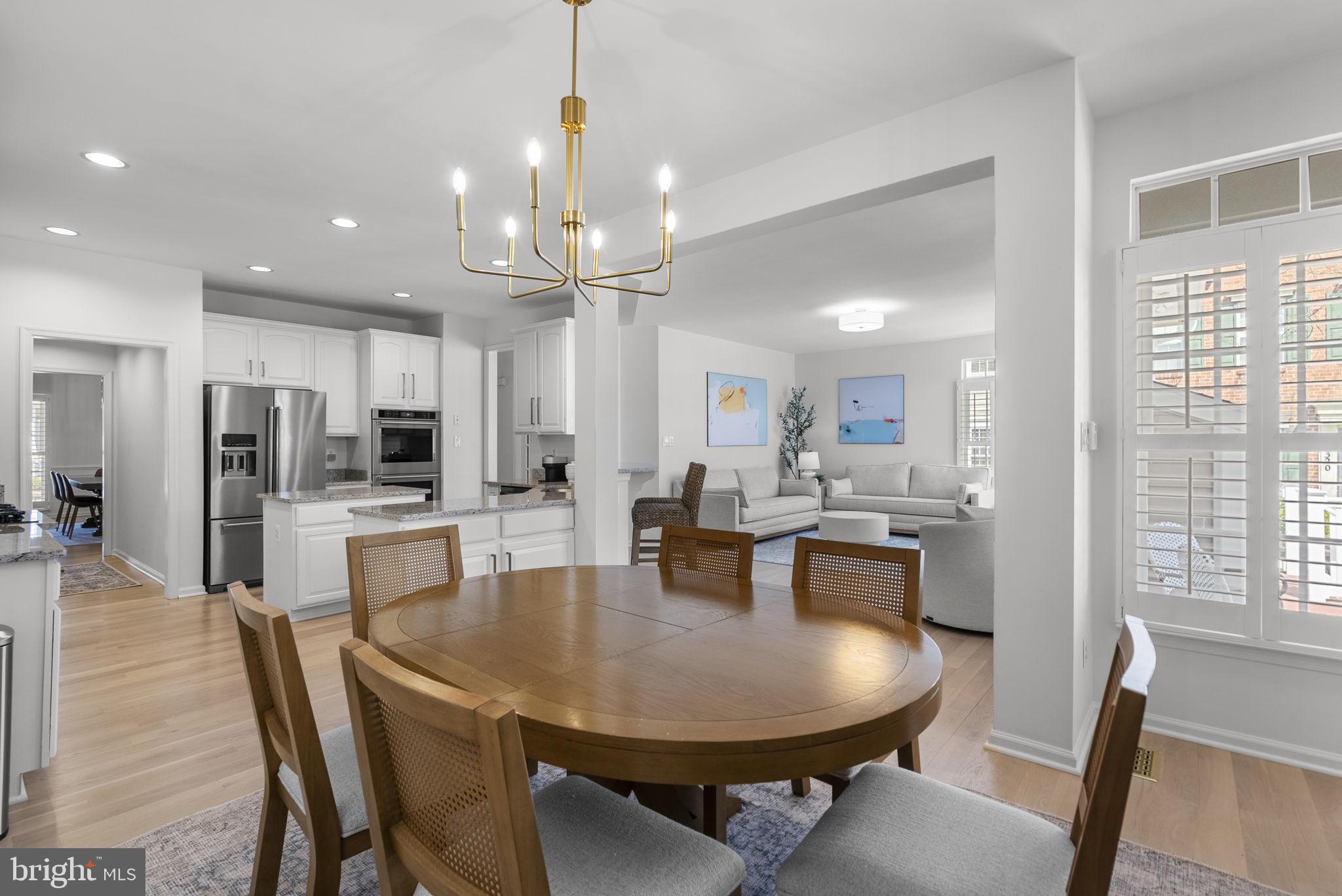 1339 Main Street Gaithersburg, MD 20878 - Photo 24 of 73 a dining room with stainless steel appliances kitchen island granite countertop a table chairs and kitchen view