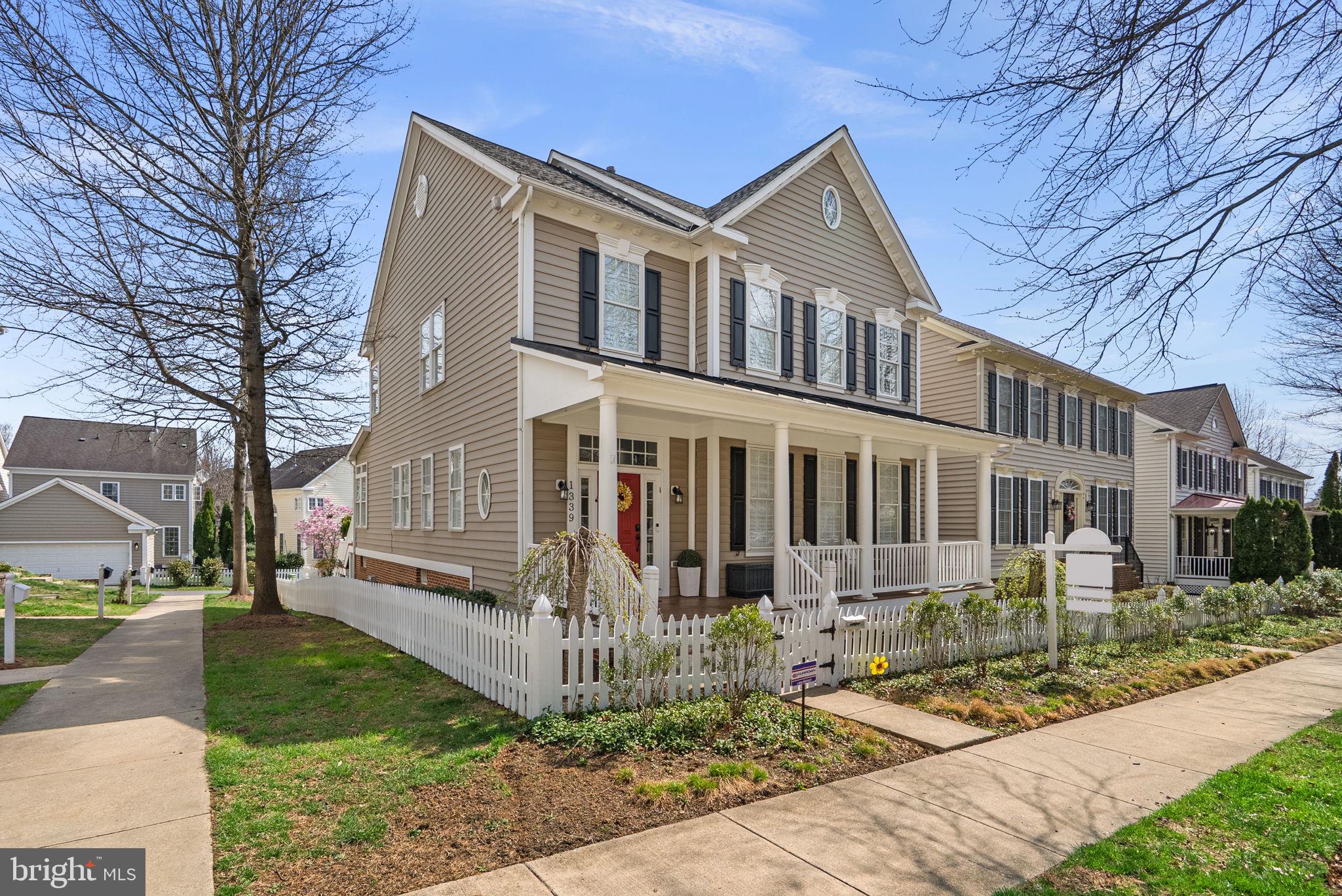 1339 Main Street Gaithersburg, MD 20878 - Photo 3 of 73 a front view of a house with a yard outdoor seating and covered with trees