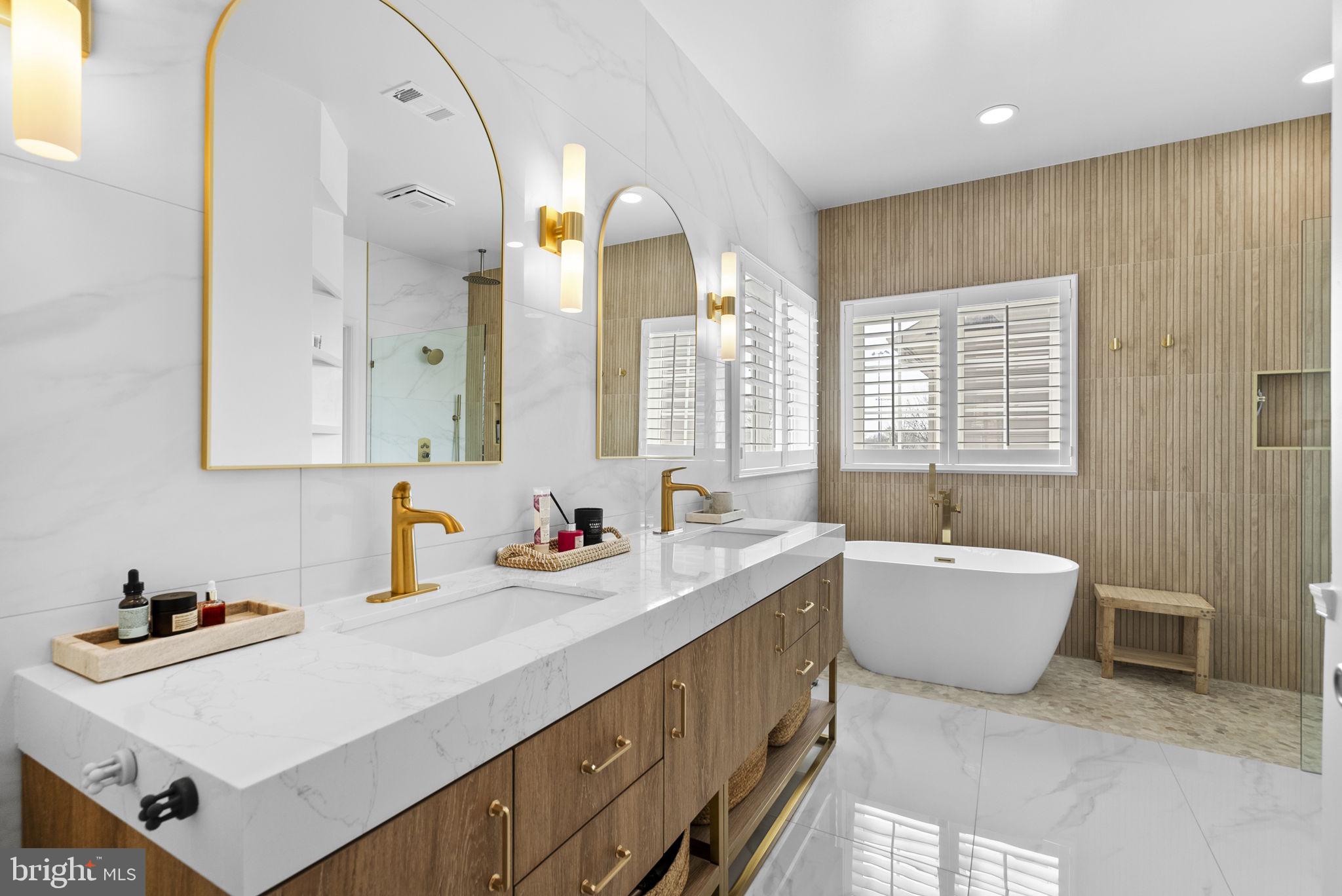 1339 Main Street Gaithersburg, MD 20878 - Photo 31 of 73 a bathroom with a tub sink and mirror