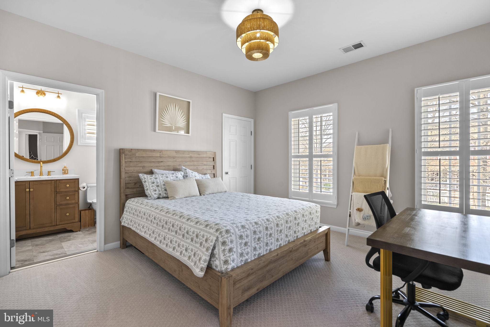1339 Main Street Gaithersburg, MD 20878 - Photo 33 of 73 a bedroom with a bed and a chandelier
