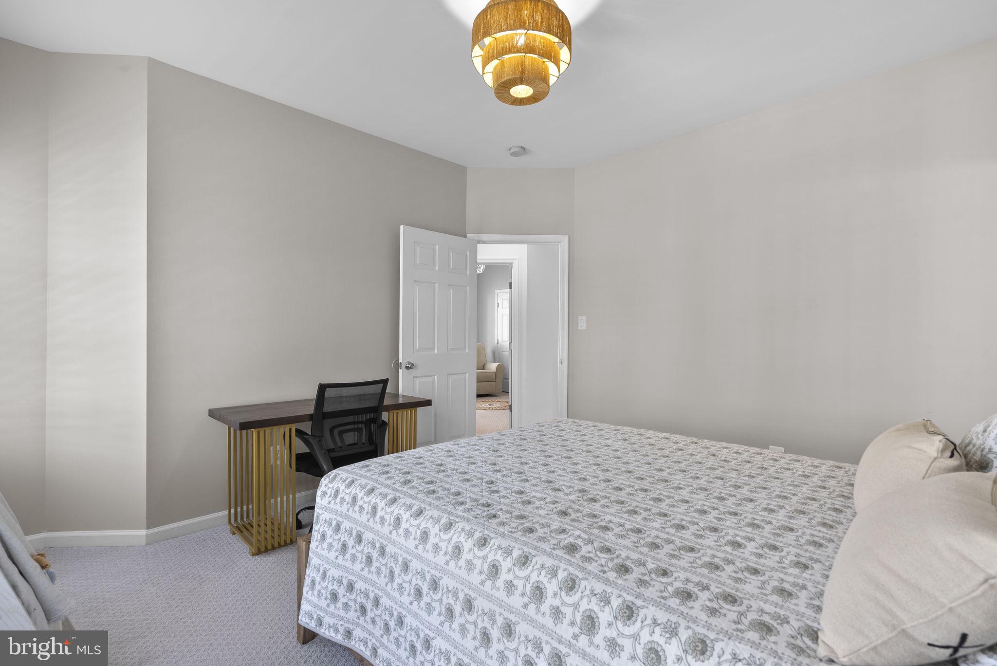 1339 Main Street Gaithersburg, MD 20878 - Photo 34 of 73 a bedroom with a bed and a lamp