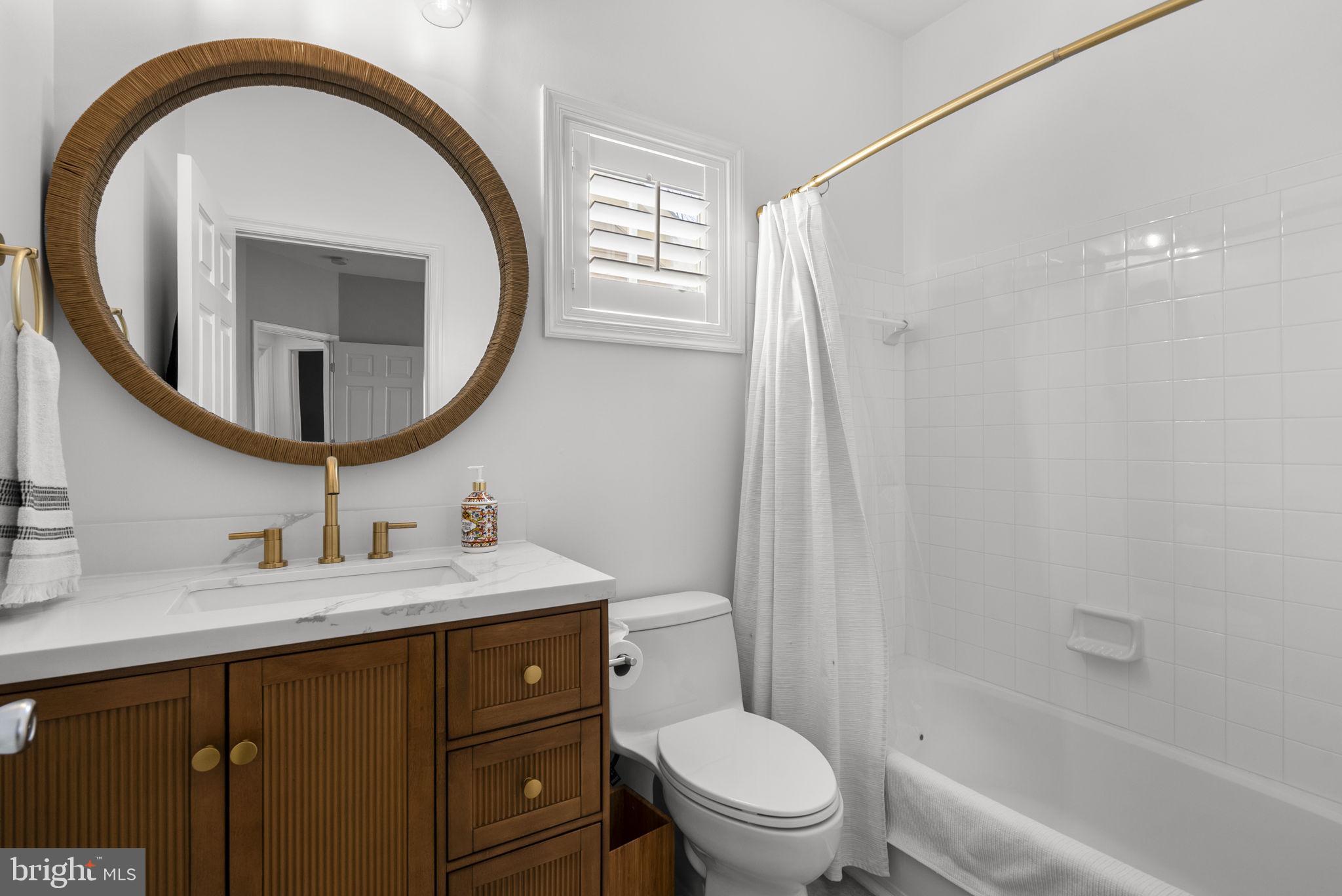 1339 Main Street Gaithersburg, MD 20878 - Photo 35 of 73 a bathroom with a sink a toilet and a mirror
