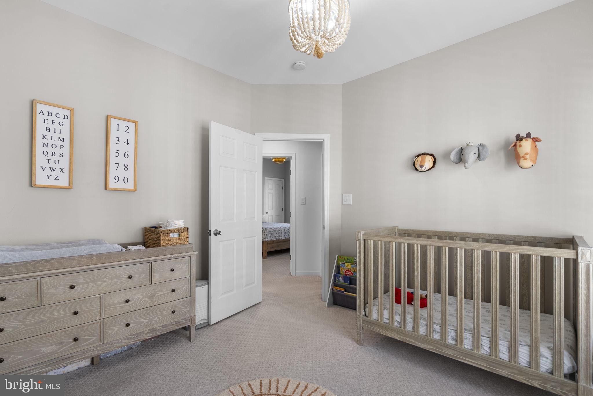 1339 Main Street Gaithersburg, MD 20878 - Photo 39 of 73 a bedroom with a bed and a baby crib