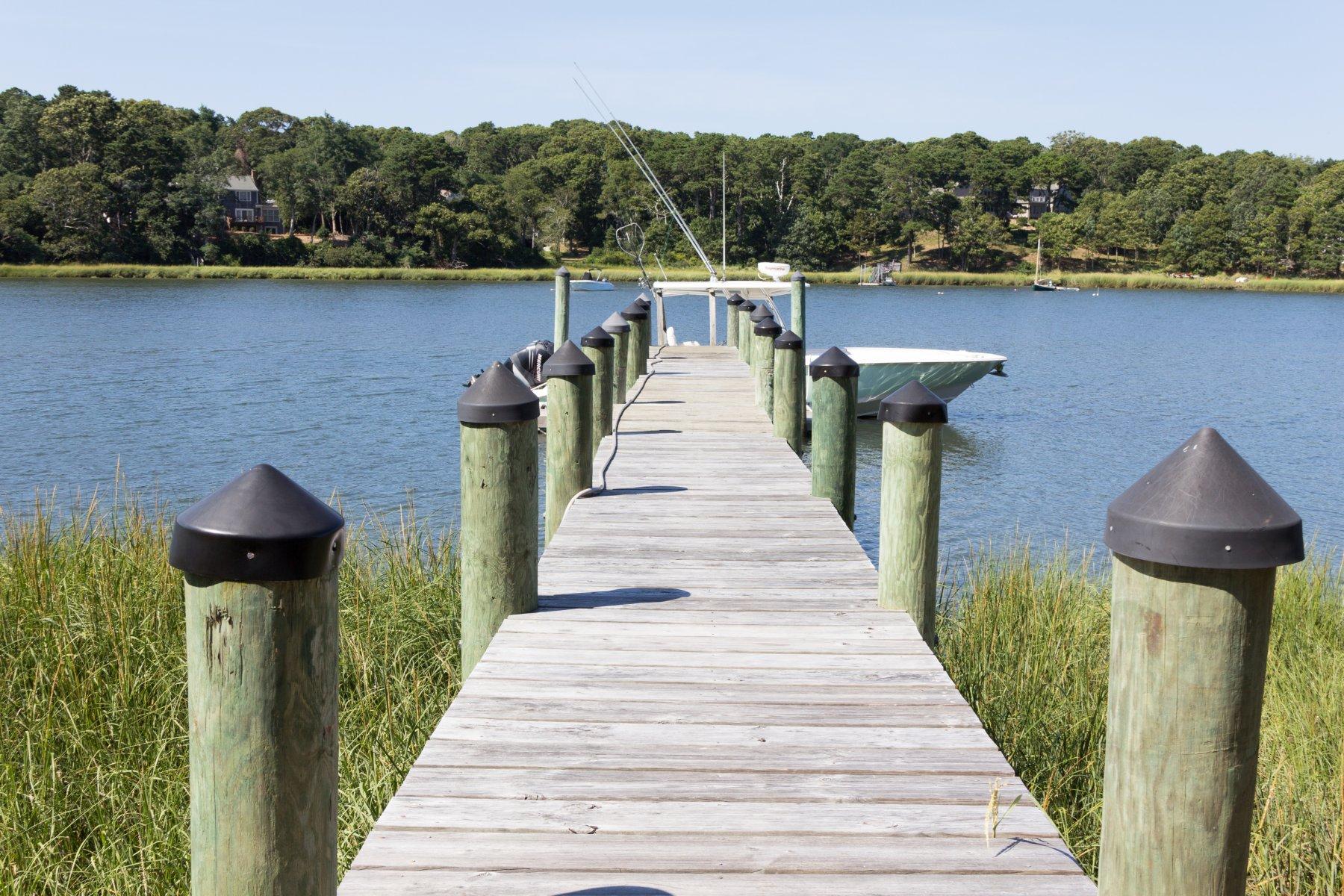 40 Viking Road Orleans, MA 02653 - Photo 1 of 27 a view of a lake with a table and a chair
