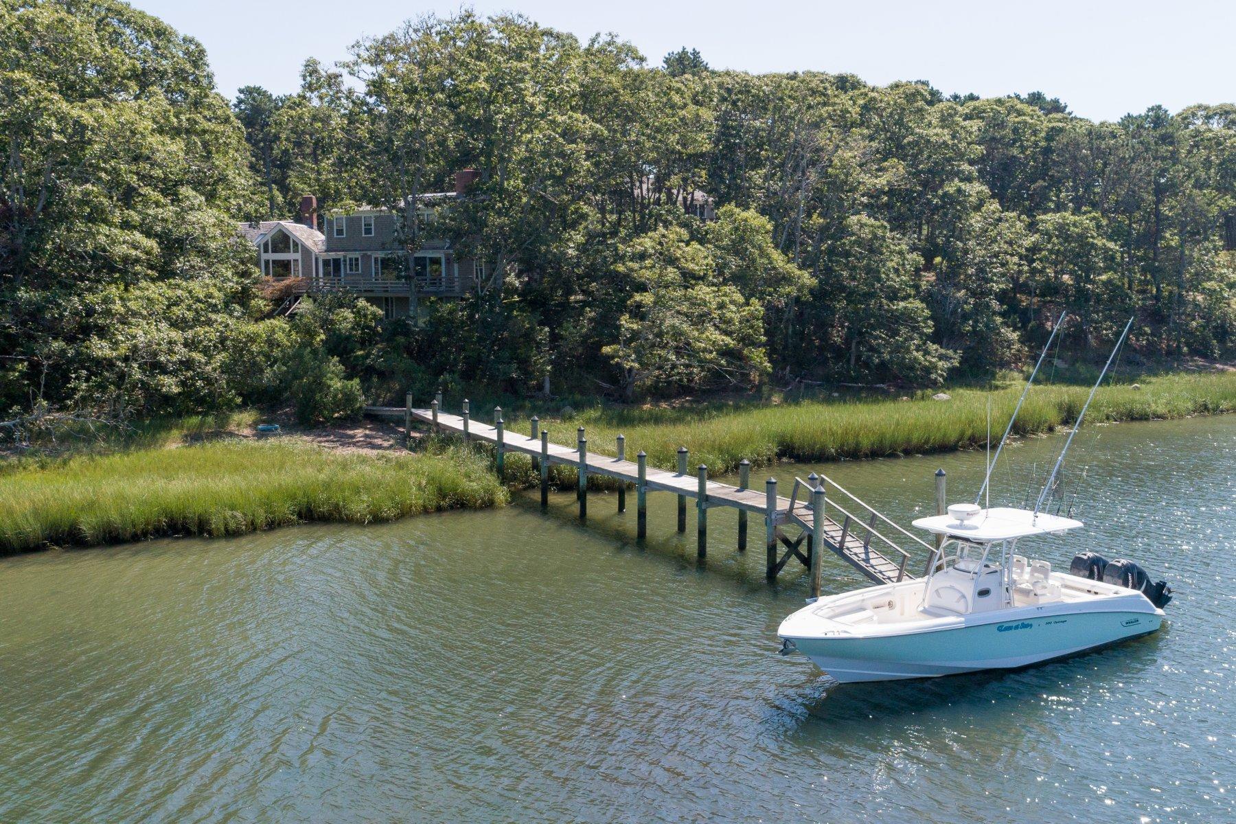 40 Viking Road Orleans, MA 02653 - Photo 25 of 27 a view of a lake with a table and a chairs