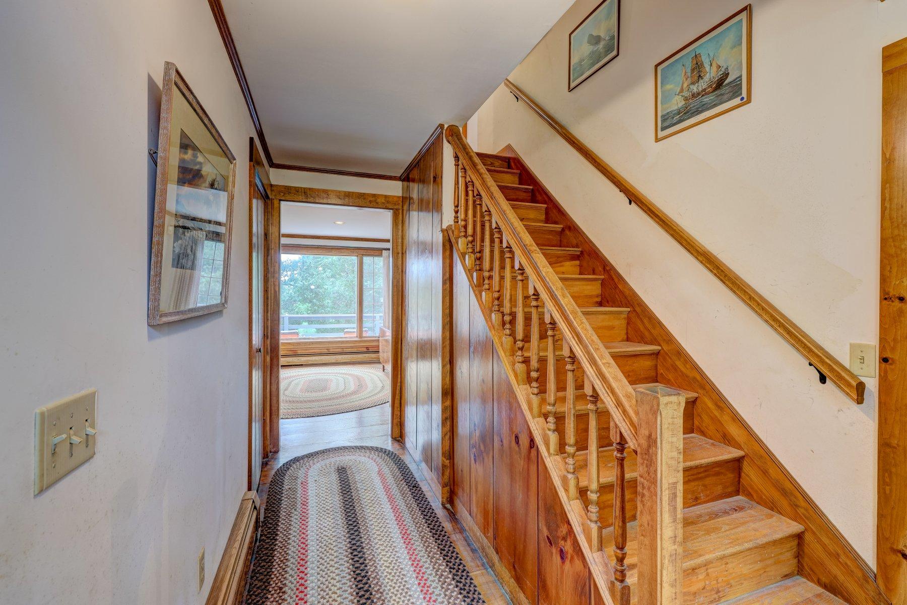40 Viking Road Orleans, MA 02653 - Photo 10 of 27 a view of staircase with wooden floor and fan
