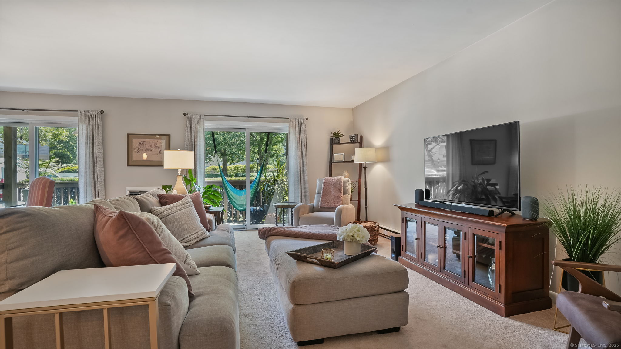 97 Richards Avenue, Unit B10 Norwalk, CT 06854 - Photo 2 of 35 a living room with furniture a flat screen tv and a large window