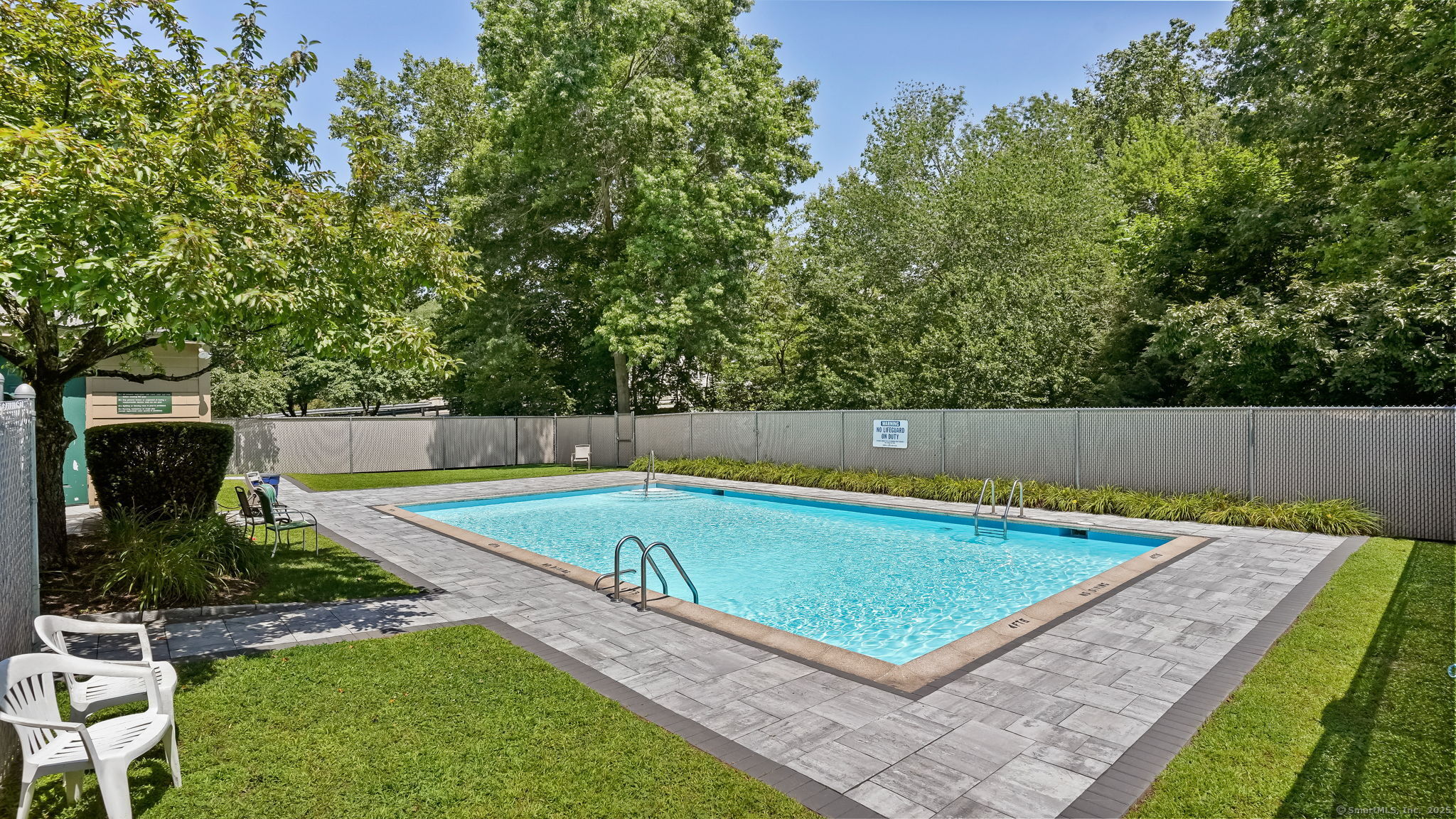 97 Richards Avenue, Unit B10 Norwalk, CT 06854 - Photo 31 of 35 a view of a backyard with a small pool and sitting area