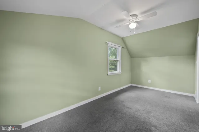 a bathroom with a sink mirror toilet and next to a window