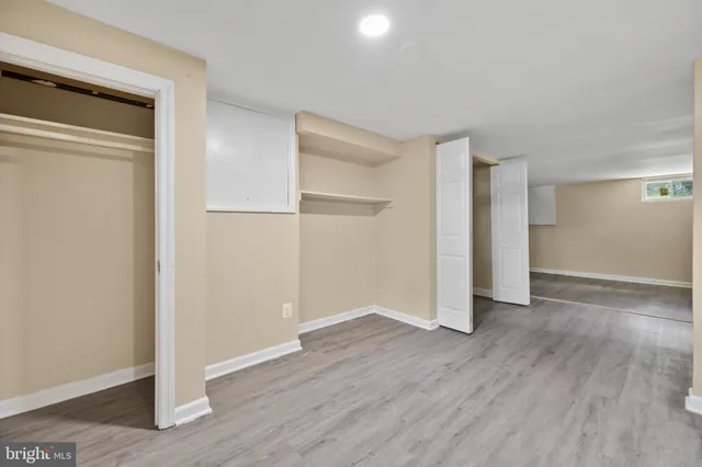 a view of a room with wooden floor and a window