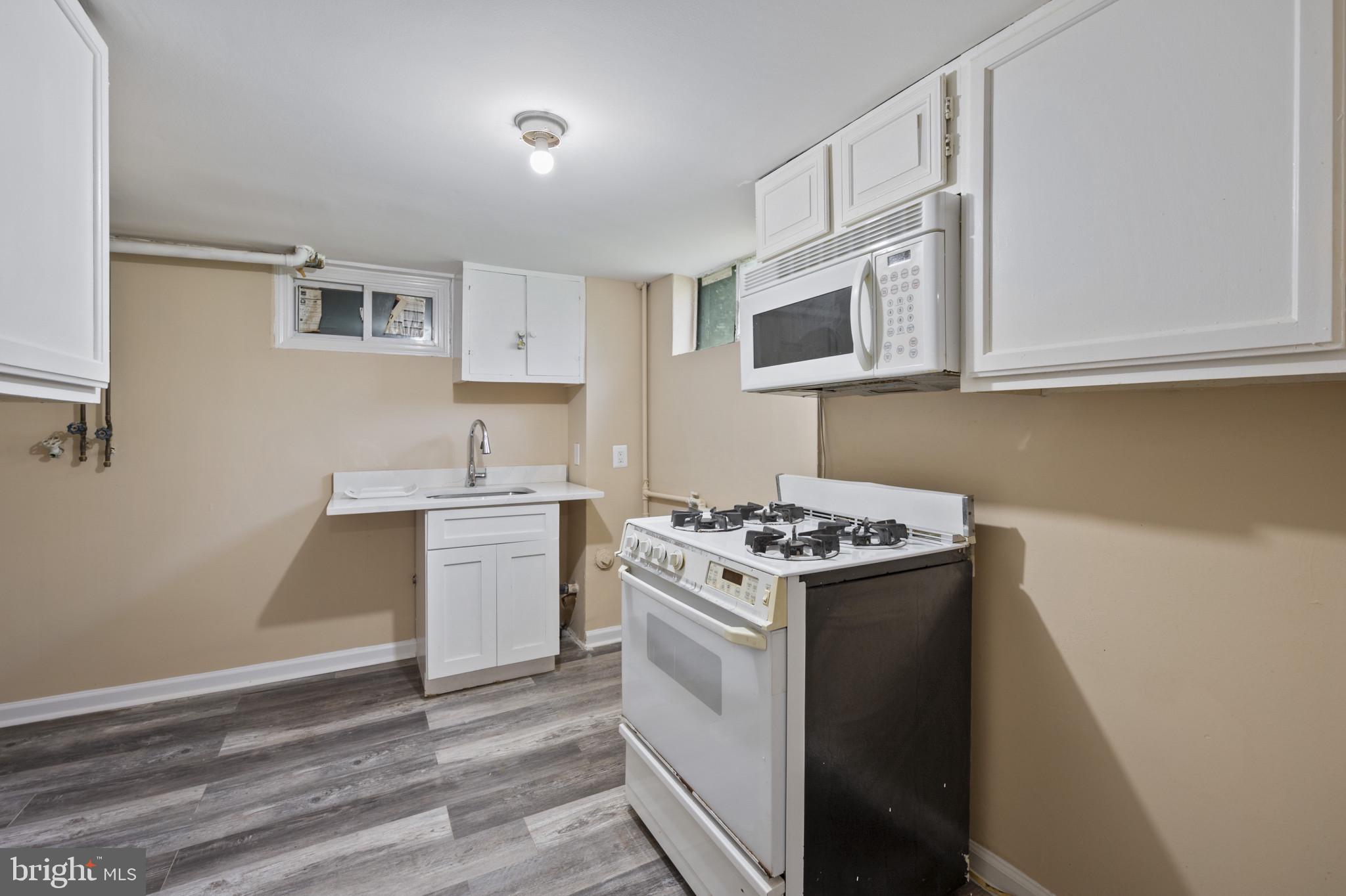 12114 Grandview Avenue Silver Spring, MD 20902 - Photo 18 of 24 a kitchen with a stove and a sink