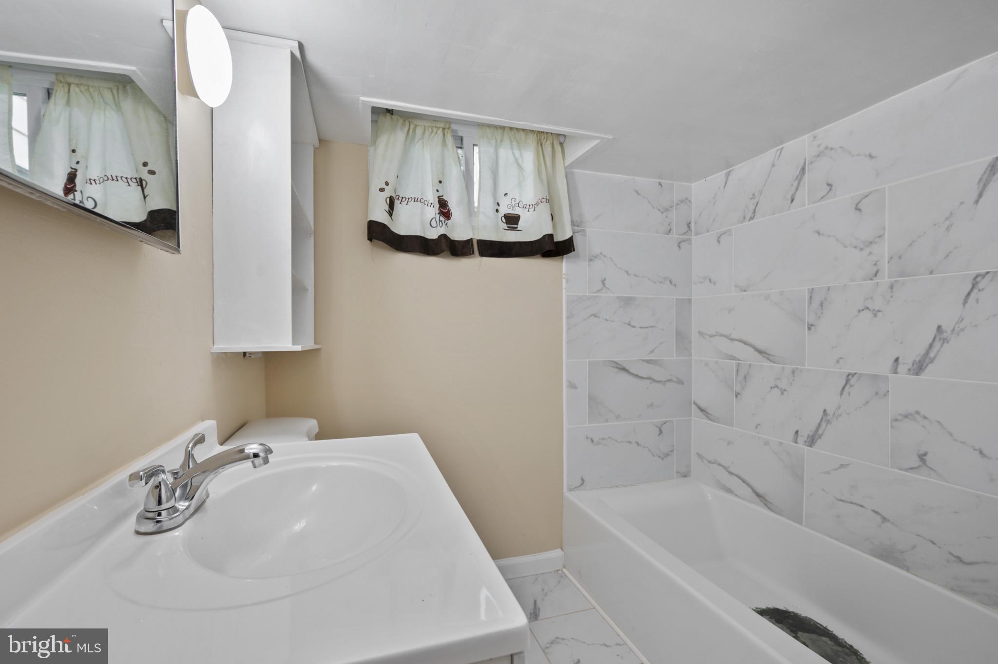 12114 Grandview Avenue Silver Spring, MD 20902 - Photo 19 of 24 a bathroom with a sink and a bathtub