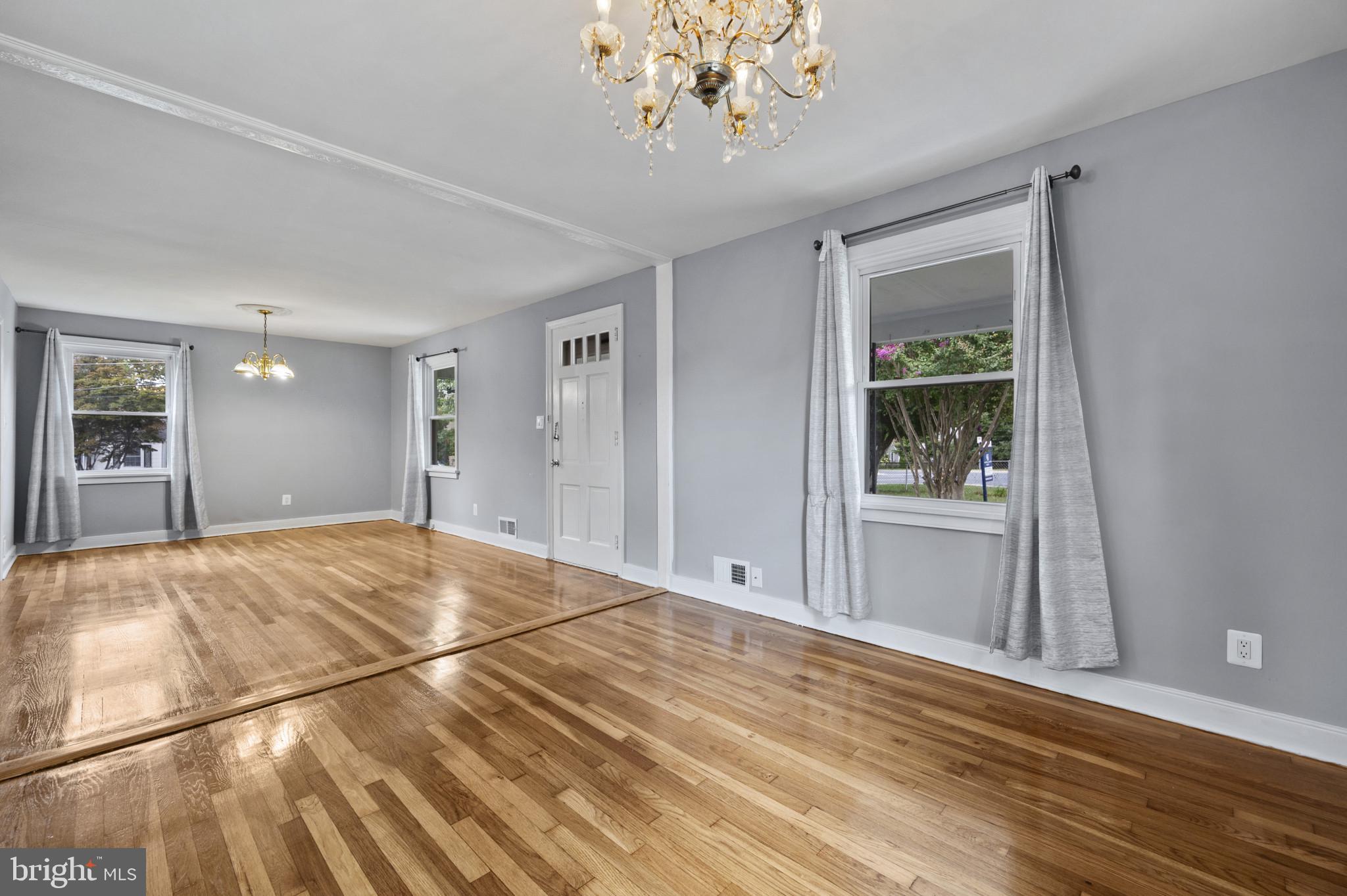 12114 Grandview Avenue Silver Spring, MD 20902 - Photo 8 of 24 a view of an empty room with wooden floor and a window