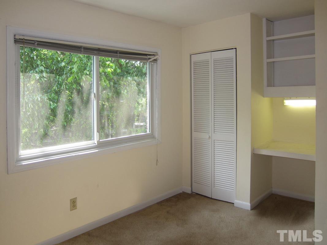 211 Church Street, Unit A8 Chapel Hill, NC 27516 - Photo 9 of 11 an empty room with a window