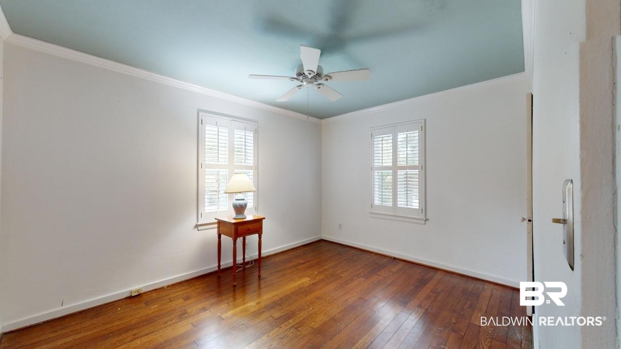 48 Hathaway Road West Mobile, AL 36608 - Photo 21 of 40 Unfurnished room featuring ceiling fan, dark hardwood / wood-style floors, and crown molding