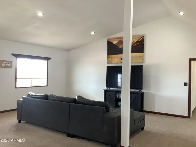 a street sign on a sidewalk next to a road