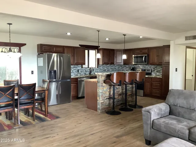a view of a livingroom with furniture and staircase