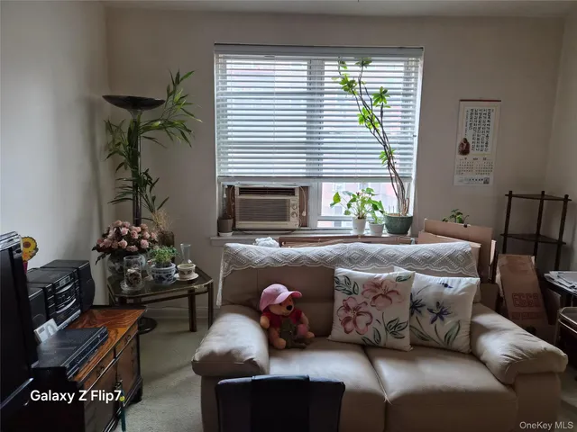 a living room with furniture wooden floor and a window