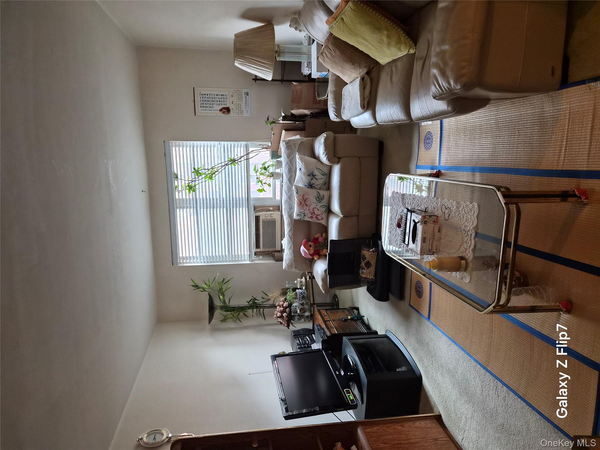 39-65 51st Street, Unit 4B Queens, NY 11377 - Photo 5 of 10 a living room with furniture wooden floor and a window