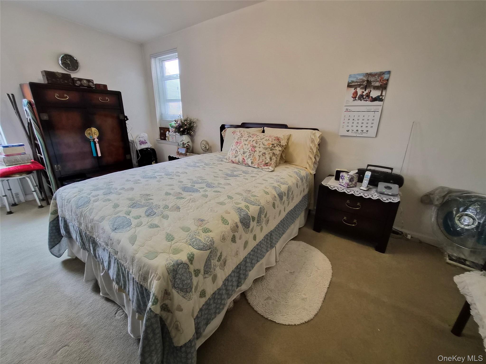 39-65 51st Street, Unit 4B Queens, NY 11377 - Photo 7 of 10 a bedroom with a bed and dresser