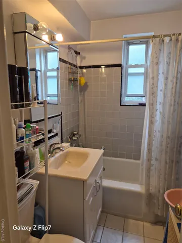 a living room with furniture a window and a flat screen tv