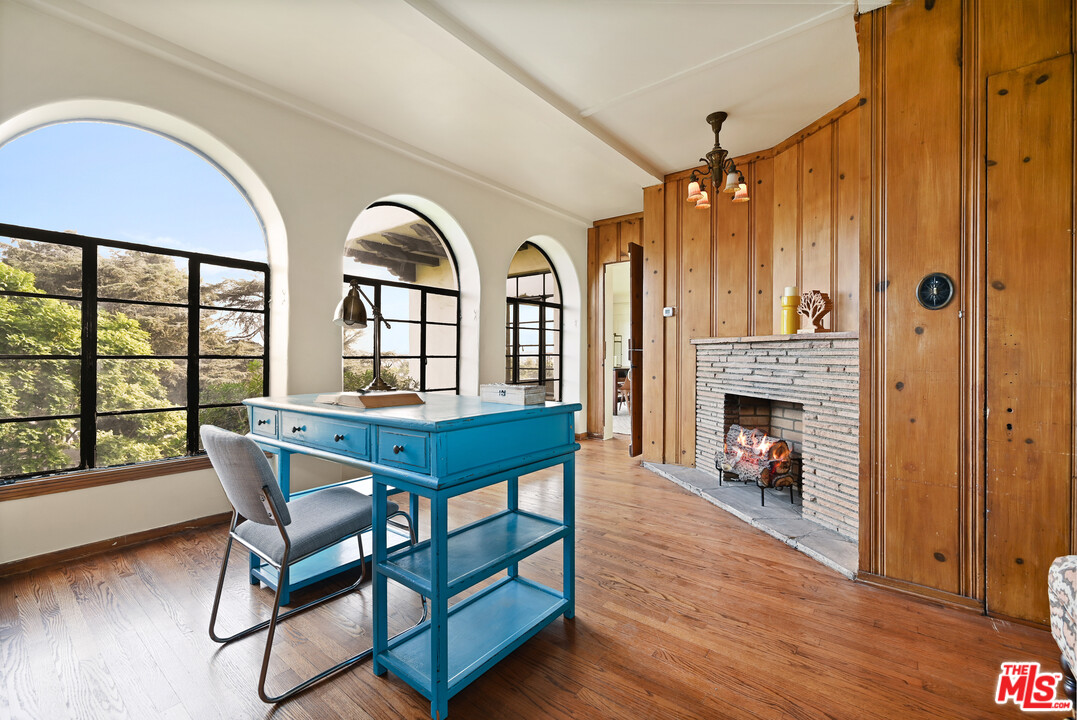 3551 Lowry Road Los Angeles, CA 90027 - Photo 14 of 50 a dining room with furniture a fireplace and wooden floor
