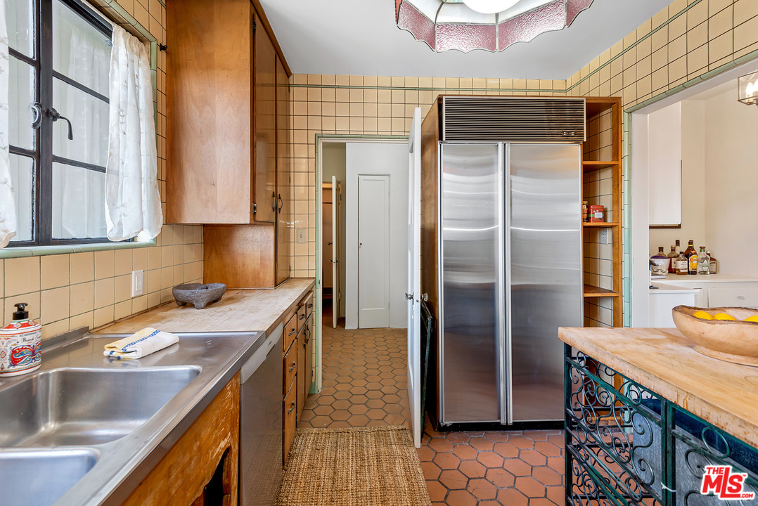 3551 Lowry Road Los Angeles, CA 90027 - Photo 20 of 50 a kitchen with stainless steel appliances granite countertop a sink and a refrigerator
