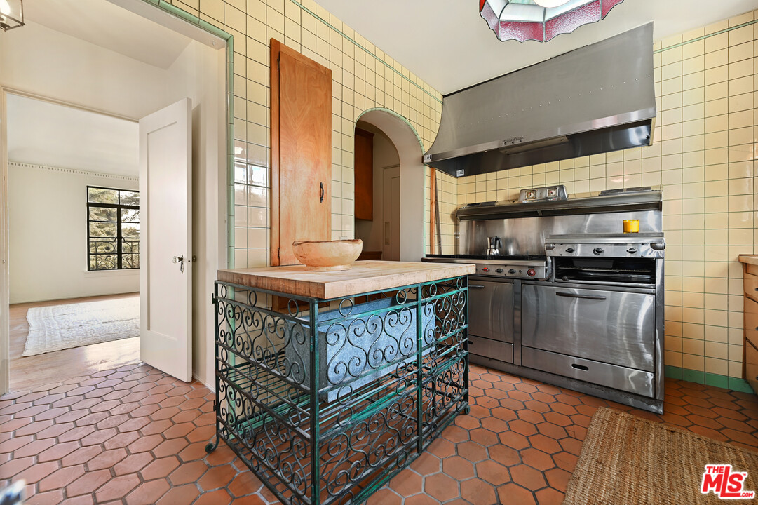 3551 Lowry Road Los Angeles, CA 90027 - Photo 21 of 50 a kitchen with stainless steel appliances kitchen island granite countertop a stove a sink and a refrigerator
