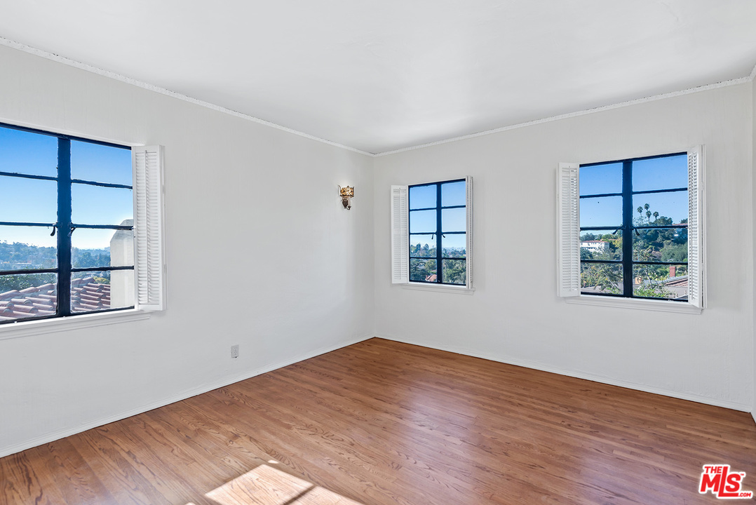 3551 Lowry Road Los Angeles, CA 90027 - Photo 27 of 50 a view of empty room with wooden floor and fan