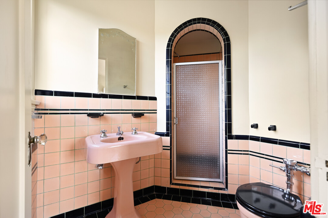 3551 Lowry Road Los Angeles, CA 90027 - Photo 28 of 50 a bathroom with a sink a toilet and mirror