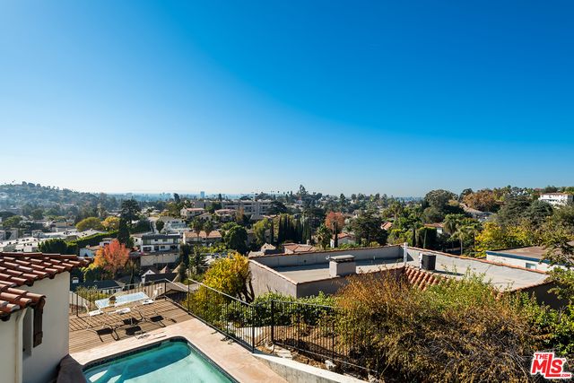 a spacious bedroom with a bed couch and window
