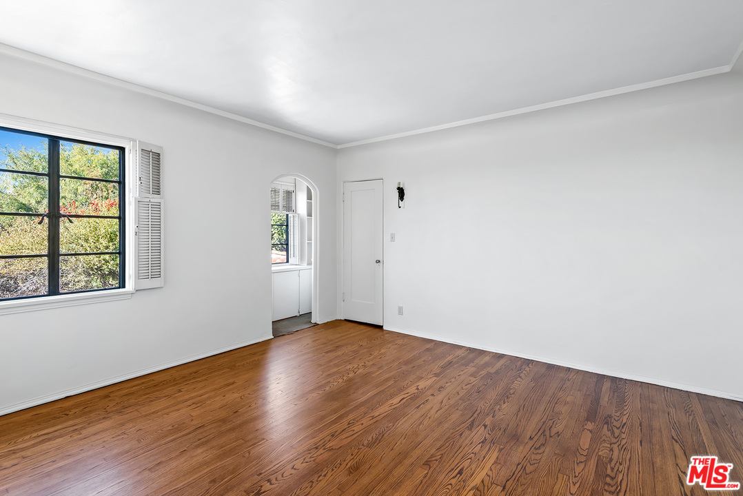3551 Lowry Road Los Angeles, CA 90027 - Photo 35 of 50 an empty room with wooden floor and windows