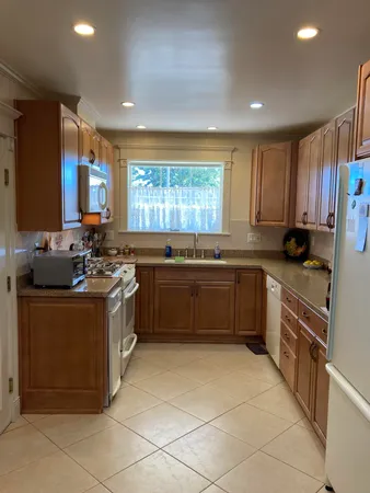 a kitchen with stainless steel appliances granite countertop a stove sink and cabinets