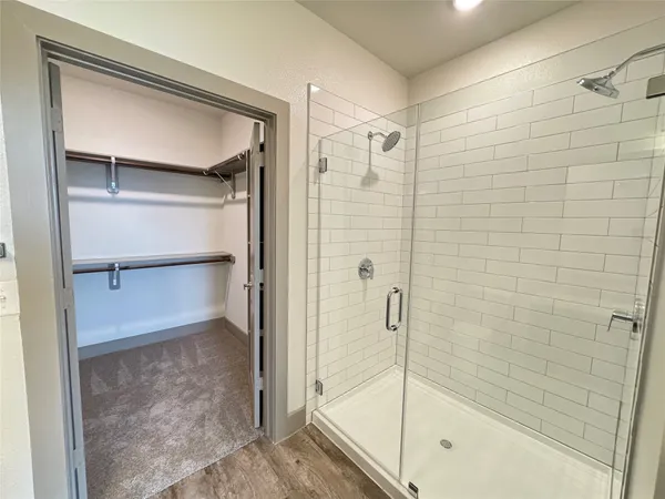 a bathroom with a glass shower door